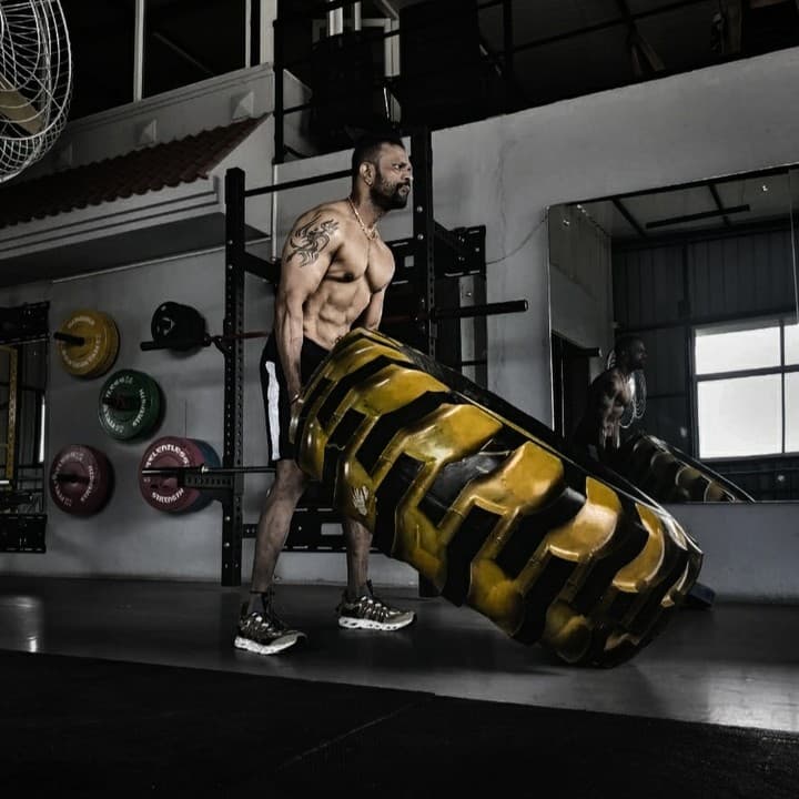 Member performing a tire flip conditioning drill